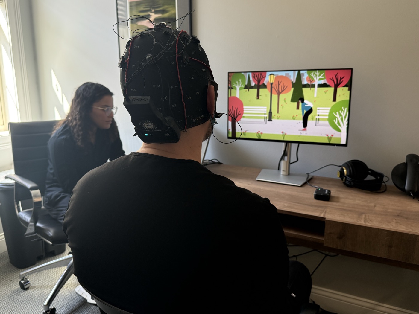 PRISM session — patient with EEG cap viewing the simulation